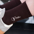 Dunkelbraune Bio-Tennissocken mit Kaffee-Stickerei kombiniert mit grauen Sneakern.