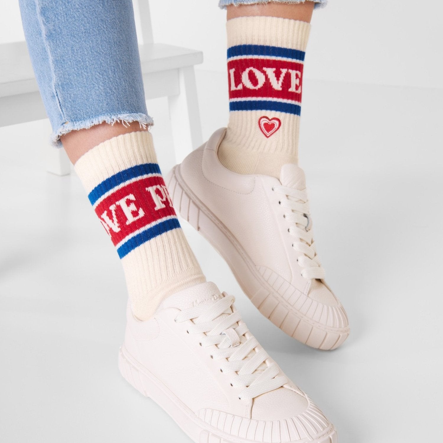 Naturweiße Bio-Tennissocken Love & Peace mit Herz-Stickerei getragen mit weißen Sneakern – Natural Vibes Clothing